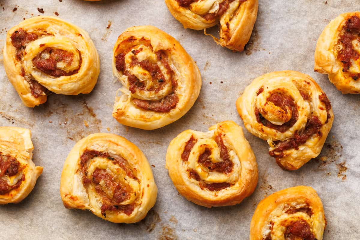 Baked lamb pinwheels on a baking sheet.