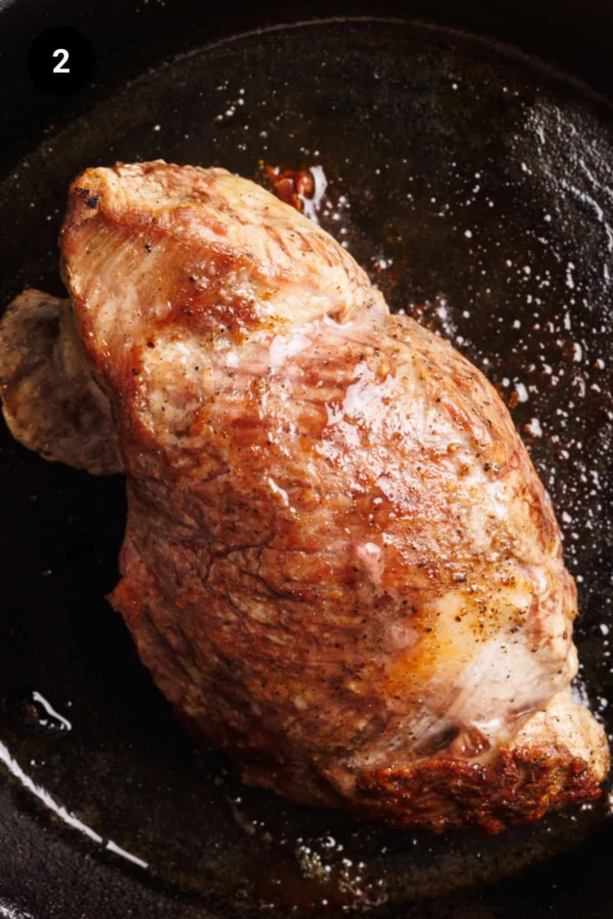 Lamb rump after being cooked in the oven in the cast iron skillet.