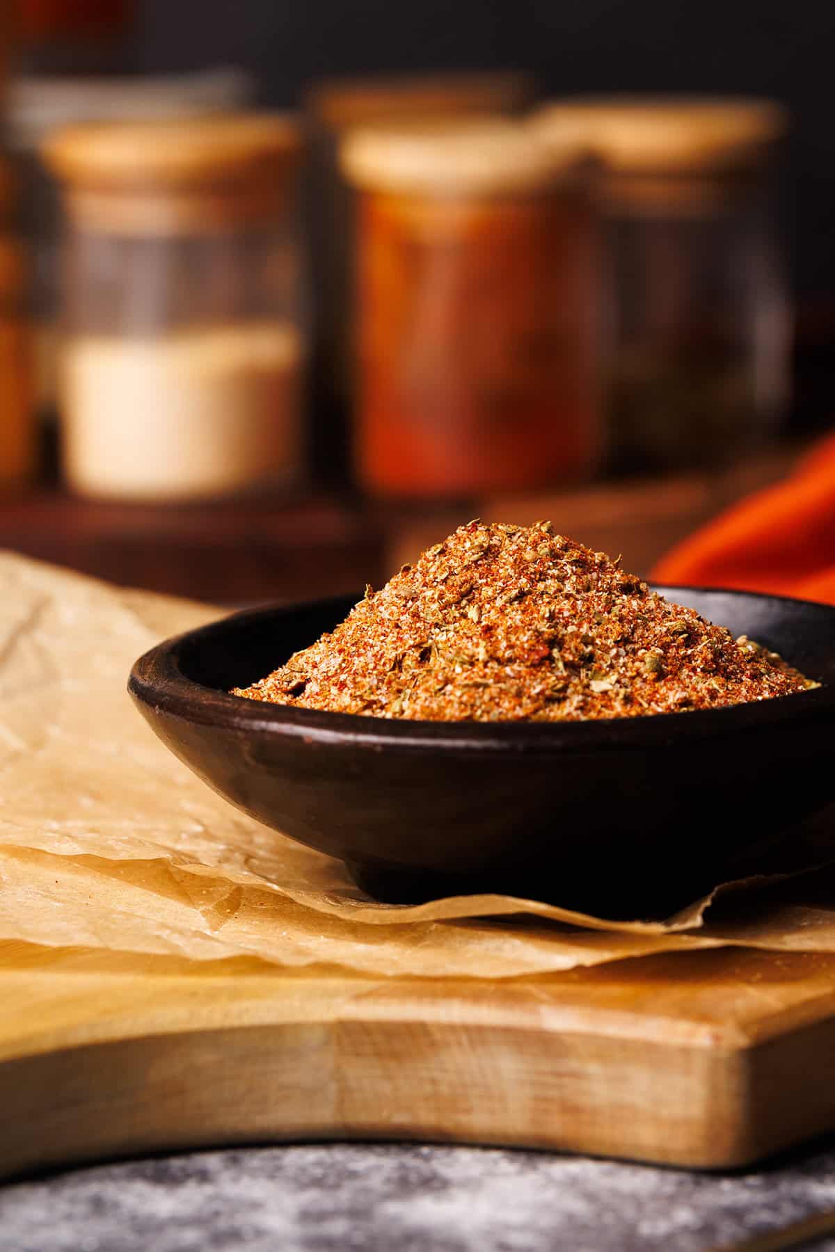 Homemade taco seasoning in a small wooden bowl.
