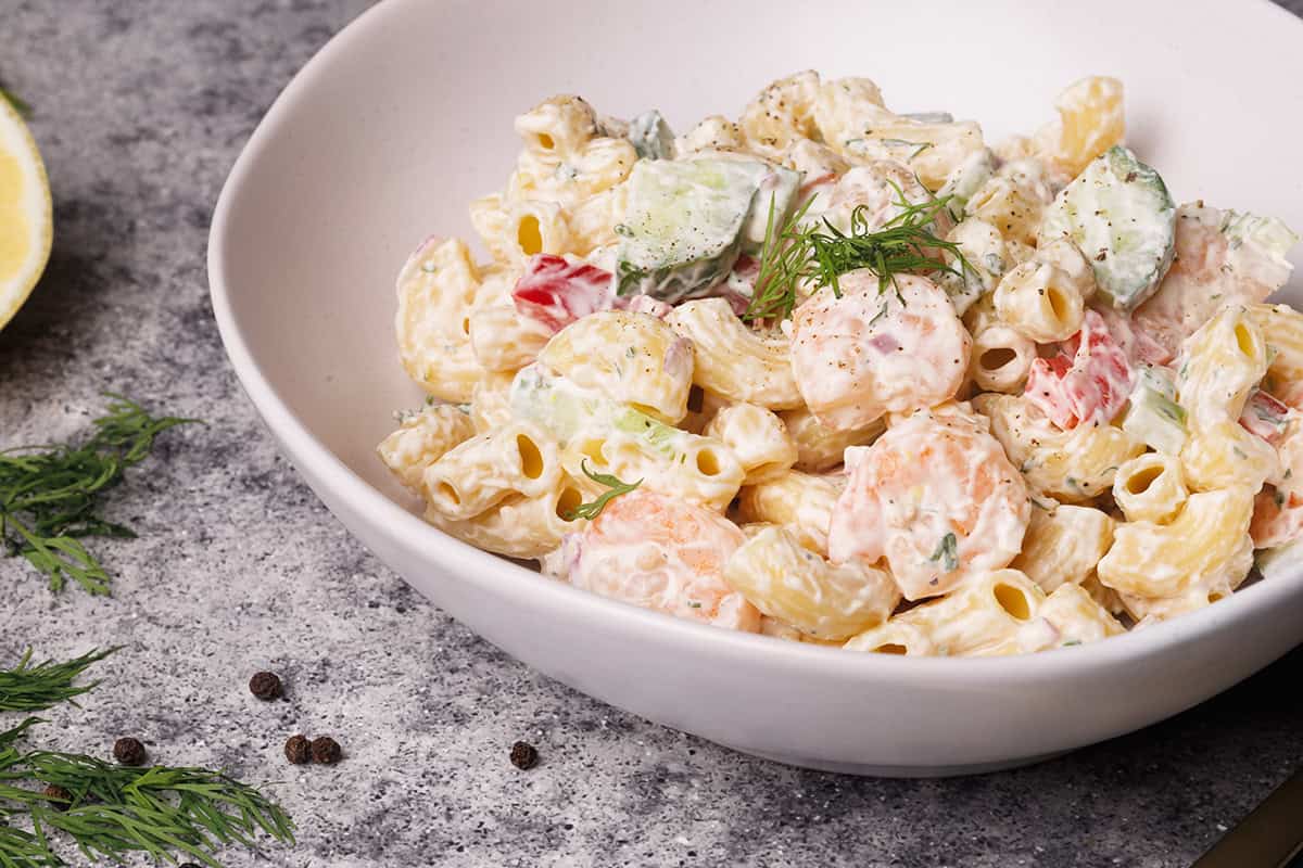 Shrimp macaroni salad in a white bowl.