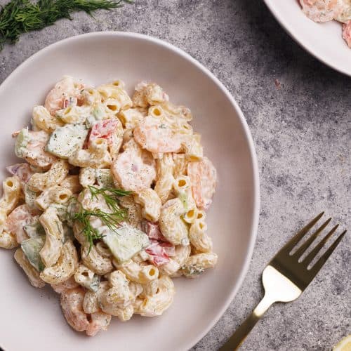 Shrimp macaroni salad in a white bowl.