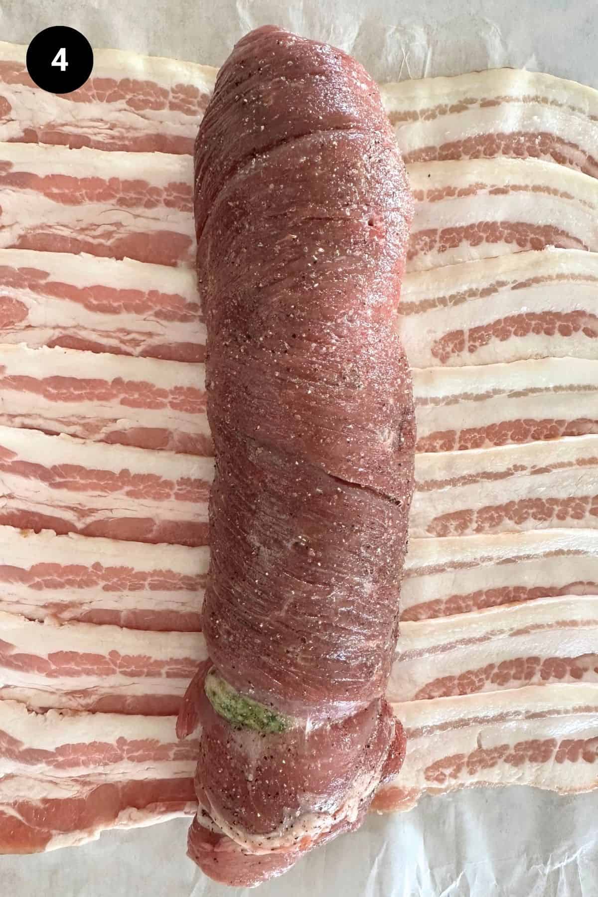 Stuffed lamb leg on a bacon strips.