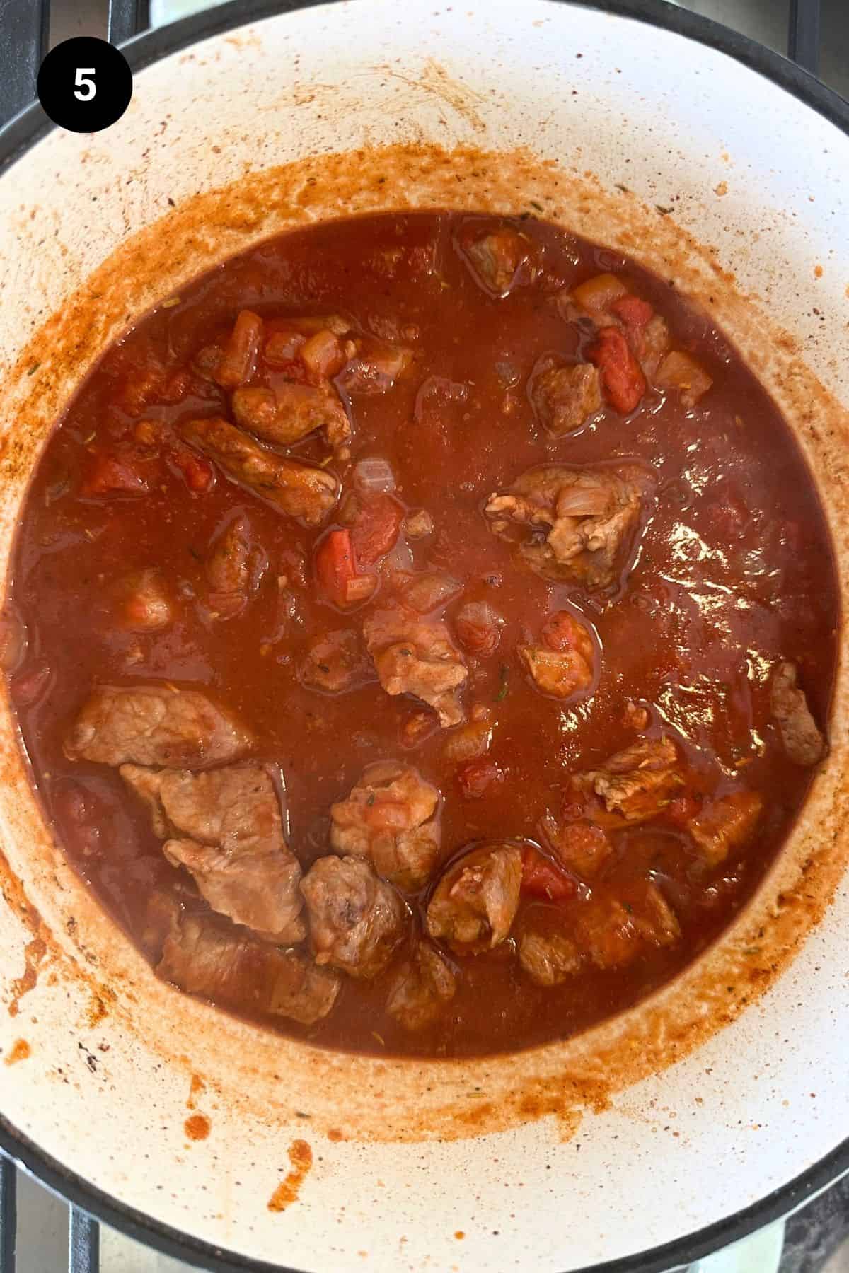 Beef pieces are put back into the stew.