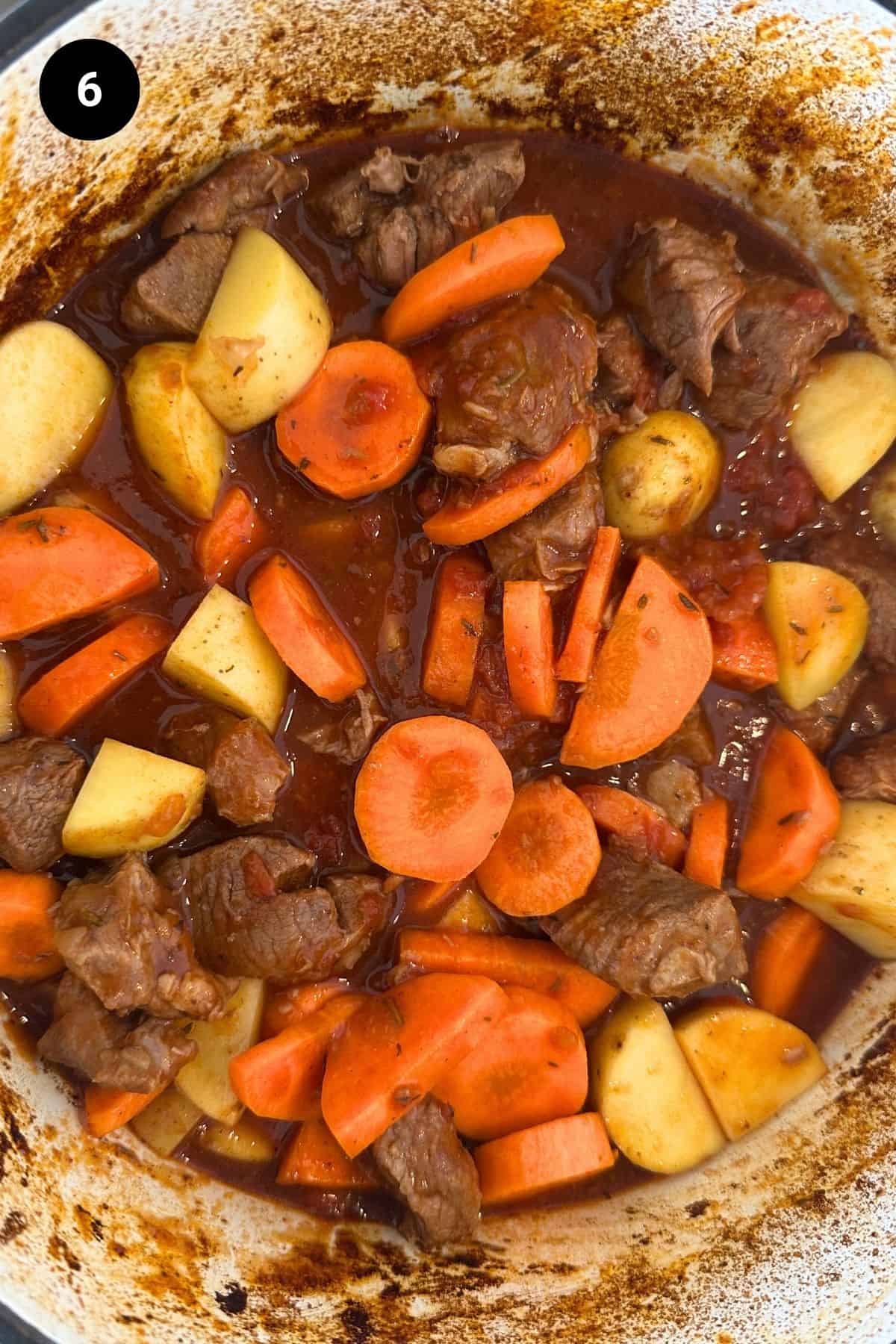 Carrots and potatoes added to the stew.