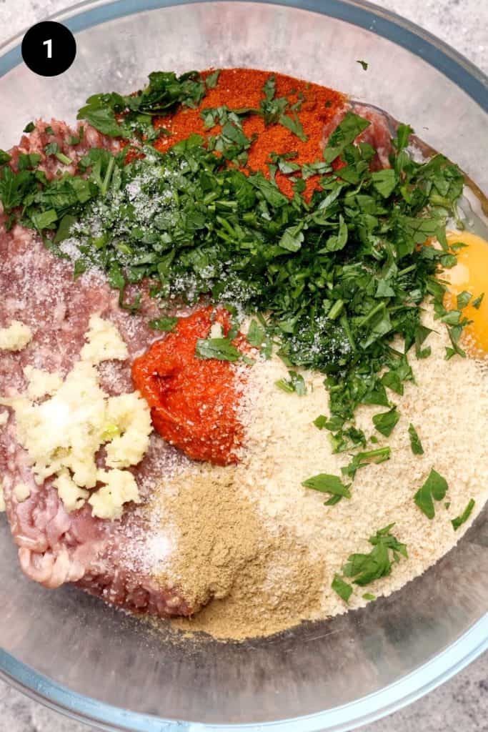 Meatball ingredients in a glass bowl.