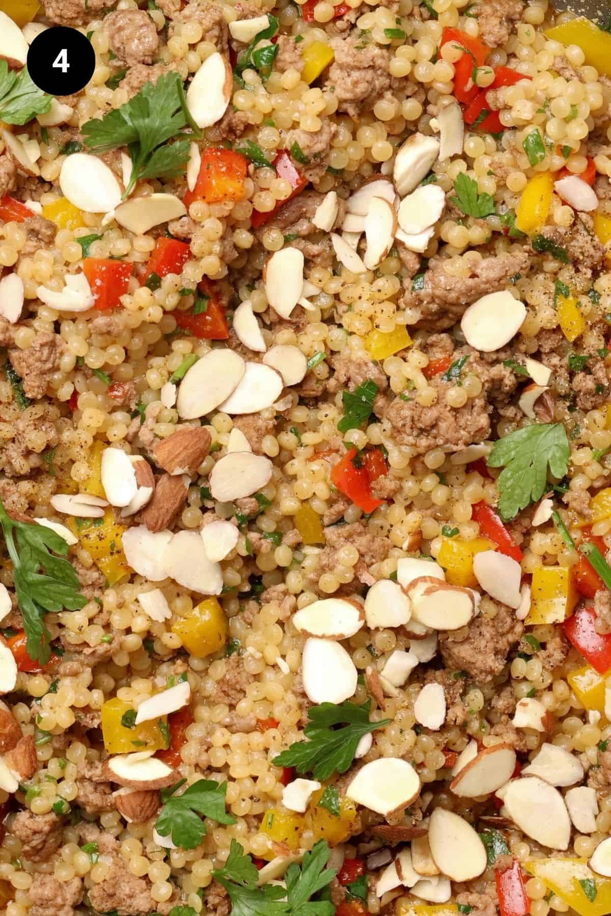 Close-up of lamb couscous with toppings.