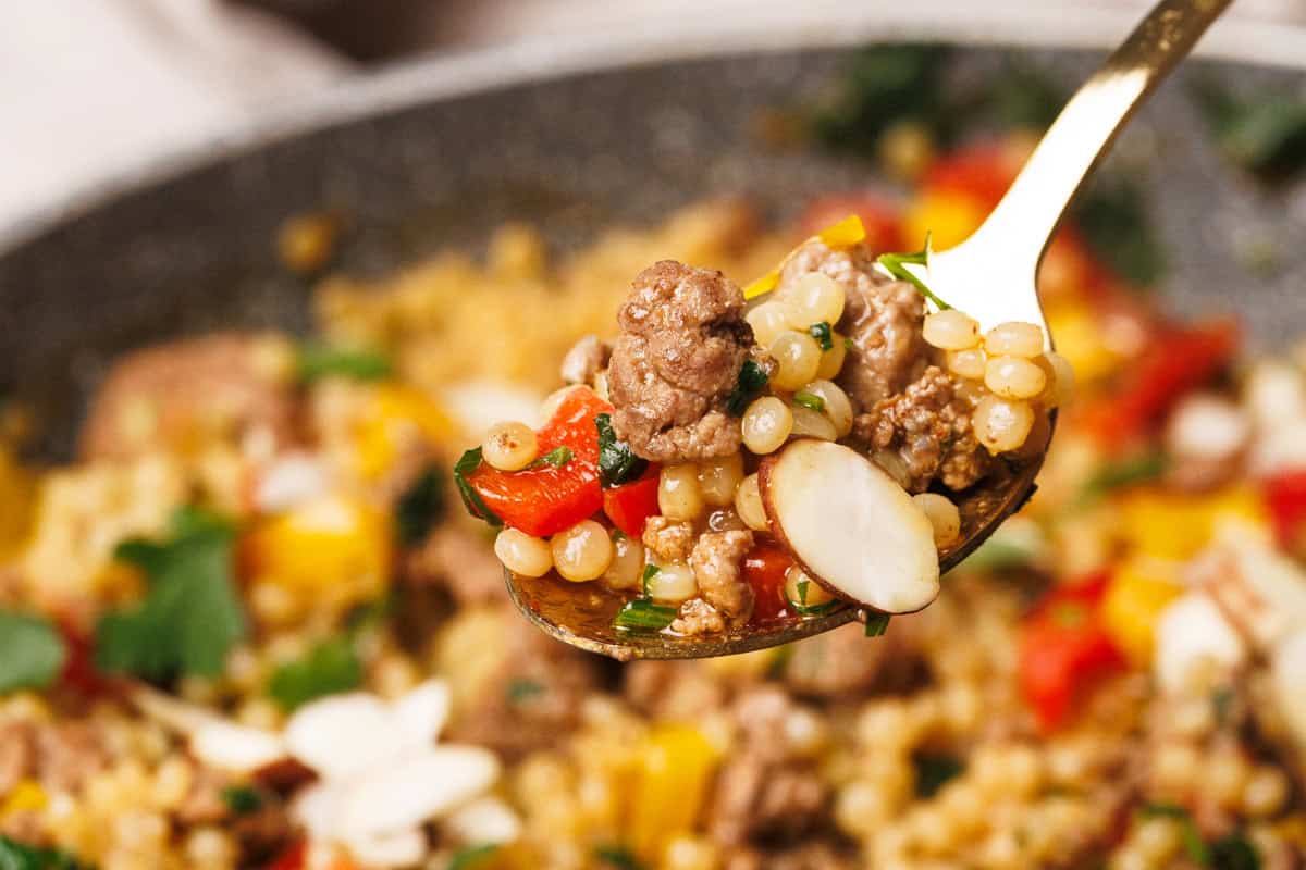 Lamb couscous on a spoon.