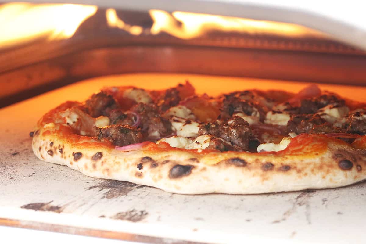 Pizza being baked in the Ooni pizza oven.