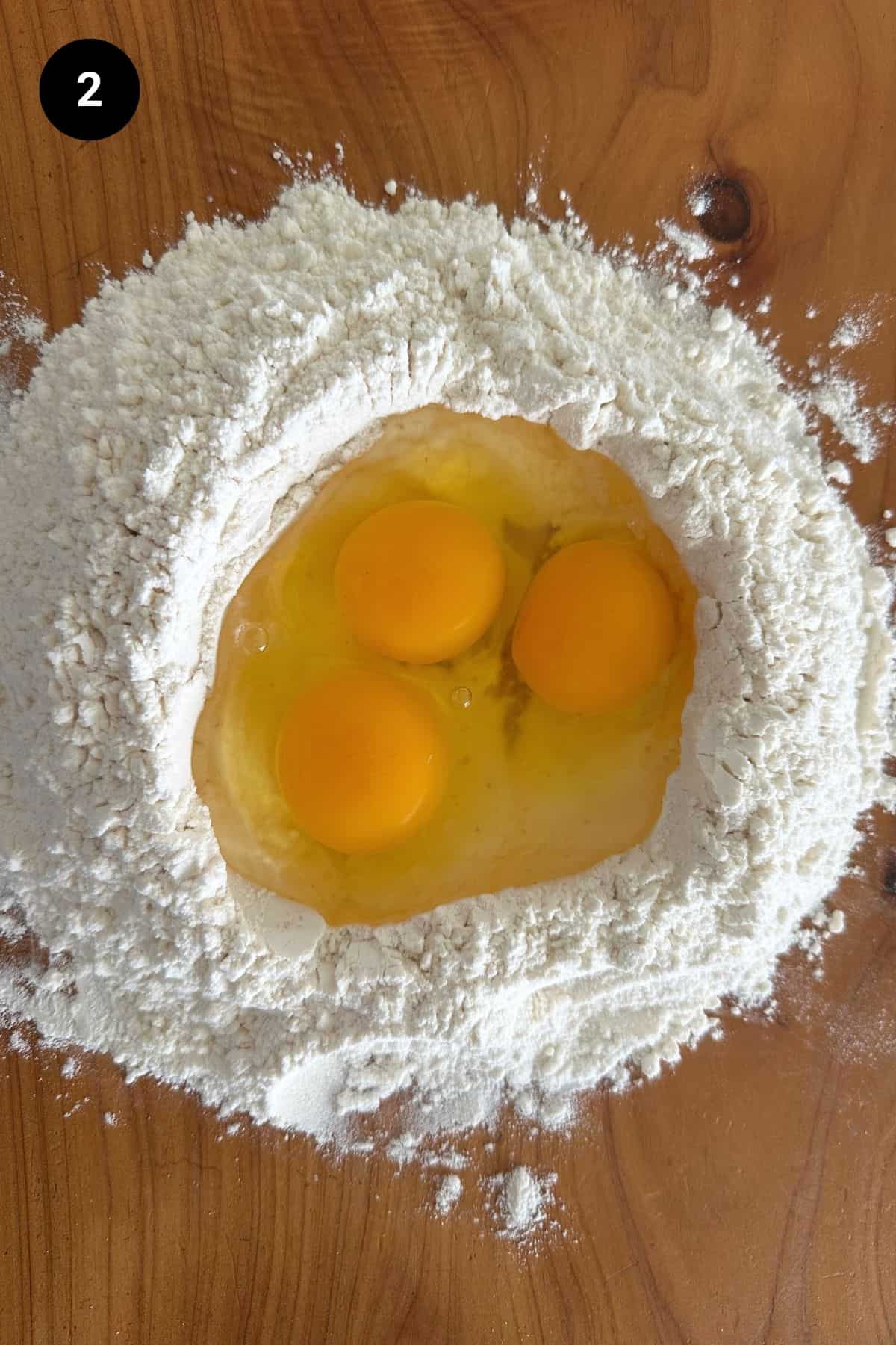 Eggs added to the flour volcano.