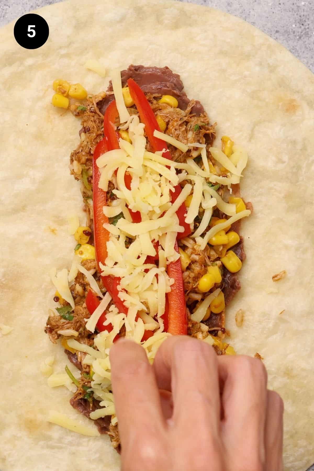 Shredded cheese added to the burrito filling.