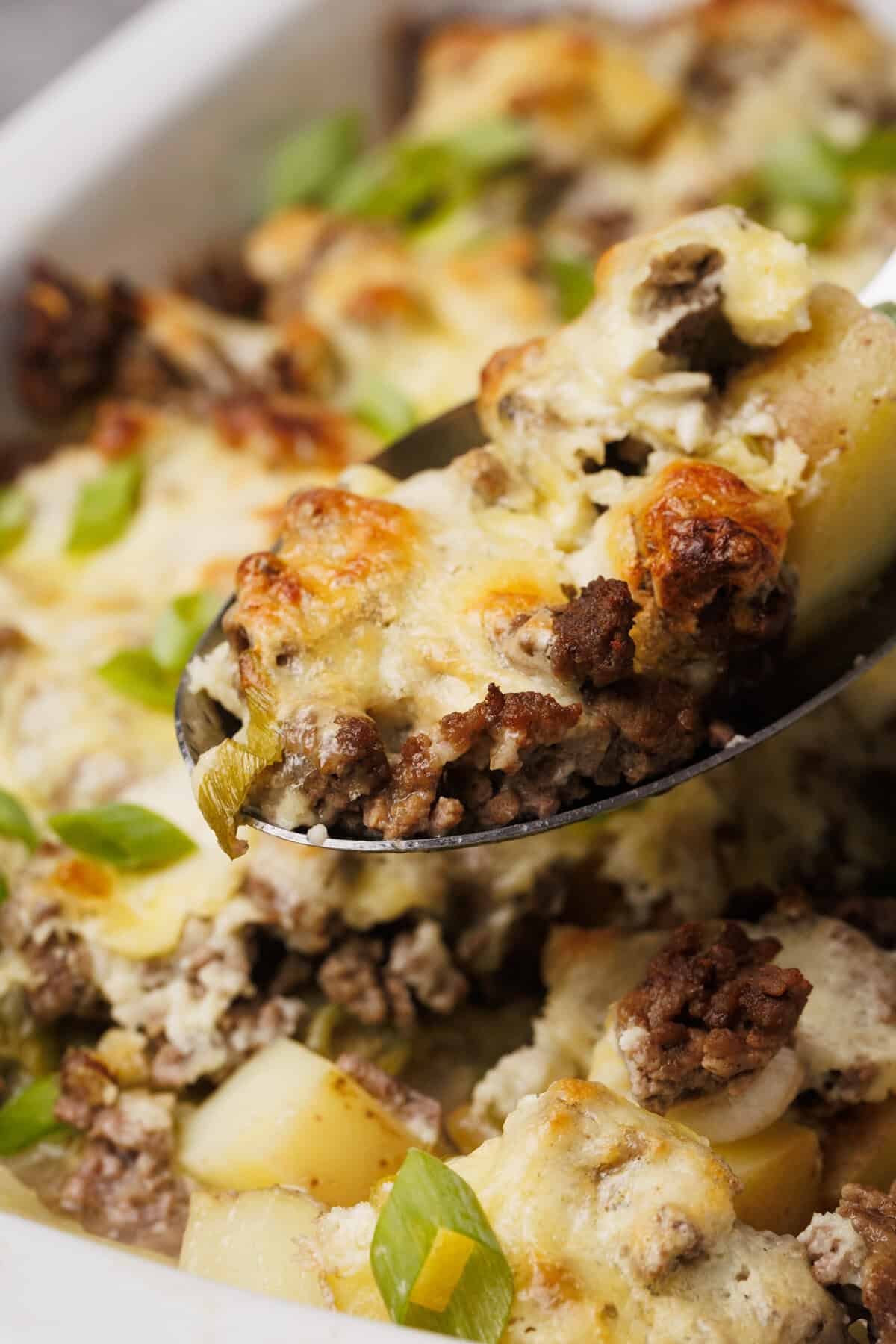 A scoop taken out of the hamburger potato casserole.