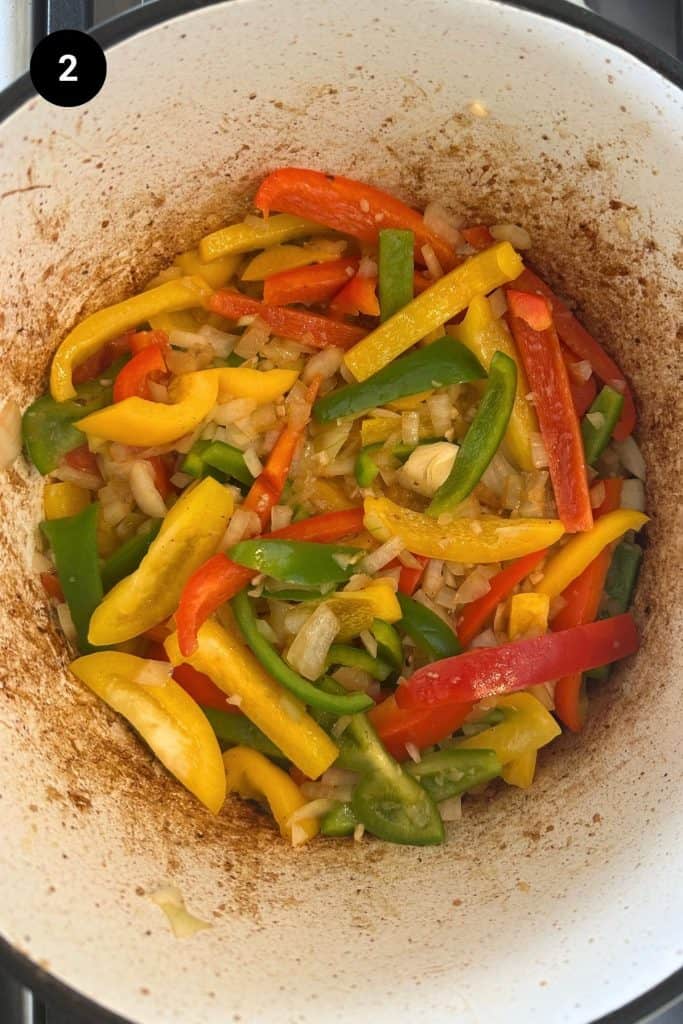 Bell peppers sautéed in a Dutch oven.
