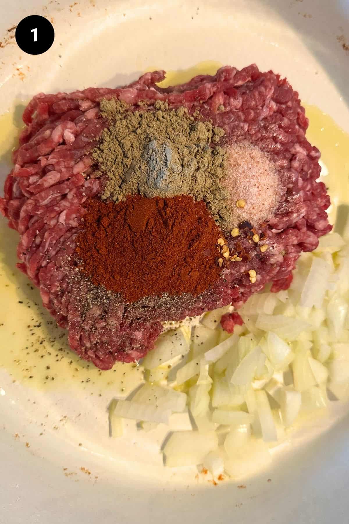 Uncooked ground beef with seasonings.