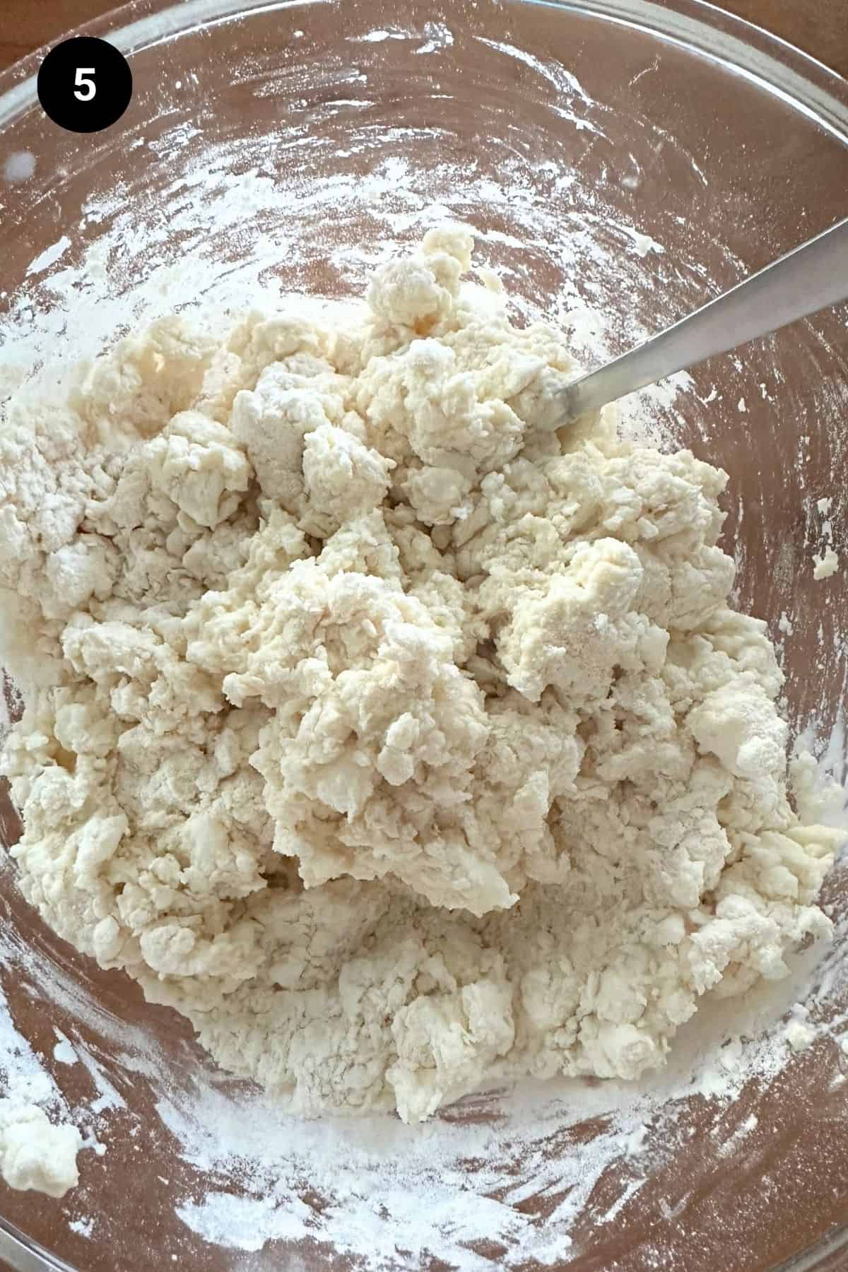 2 ingredient biscuit shaggy dough in a glass bowl.
