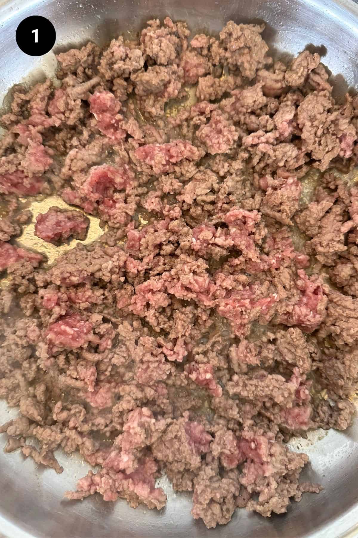 Ground beef being browned in a pan.