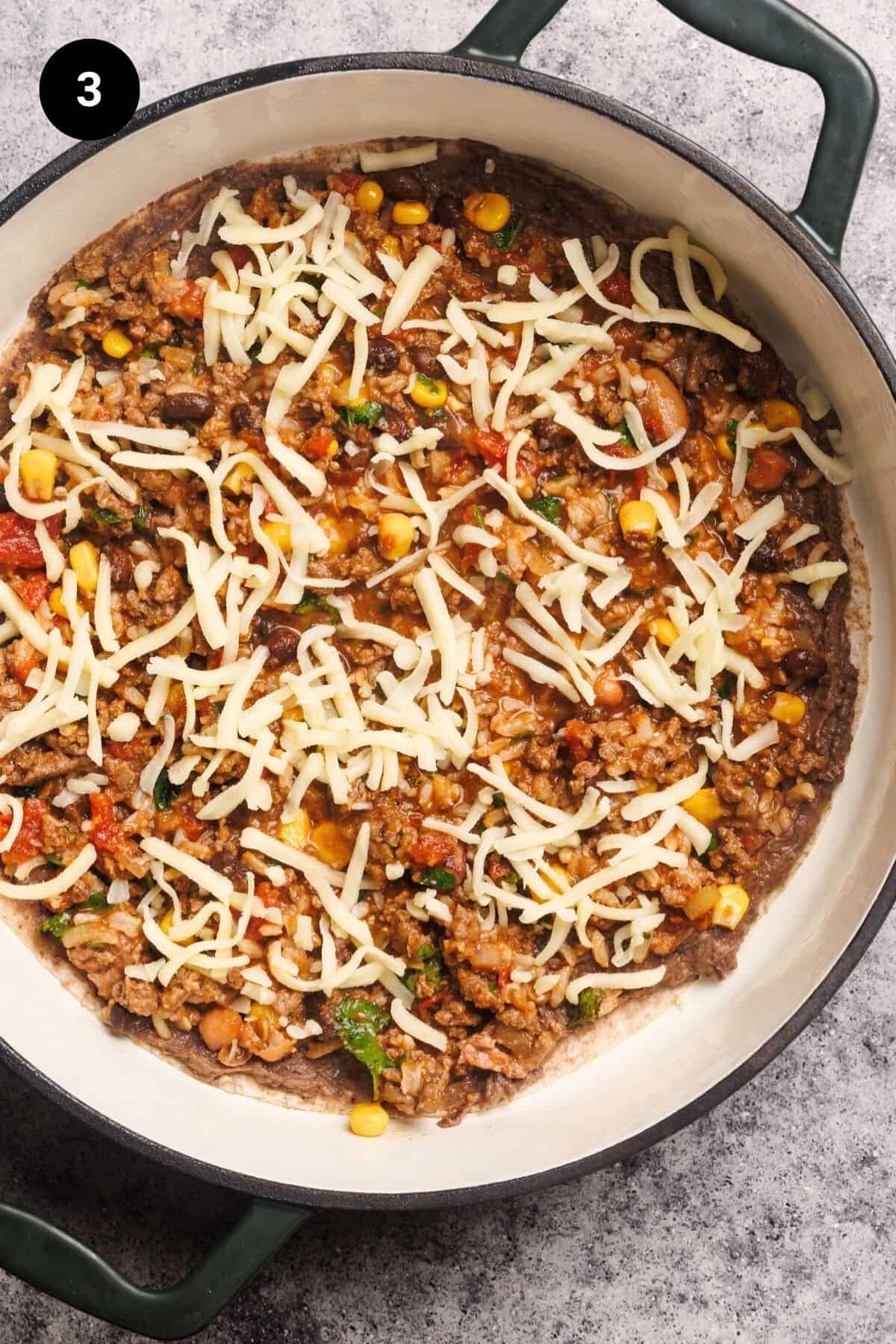 First layer of the Mexican lasagna in a round casserole dish.