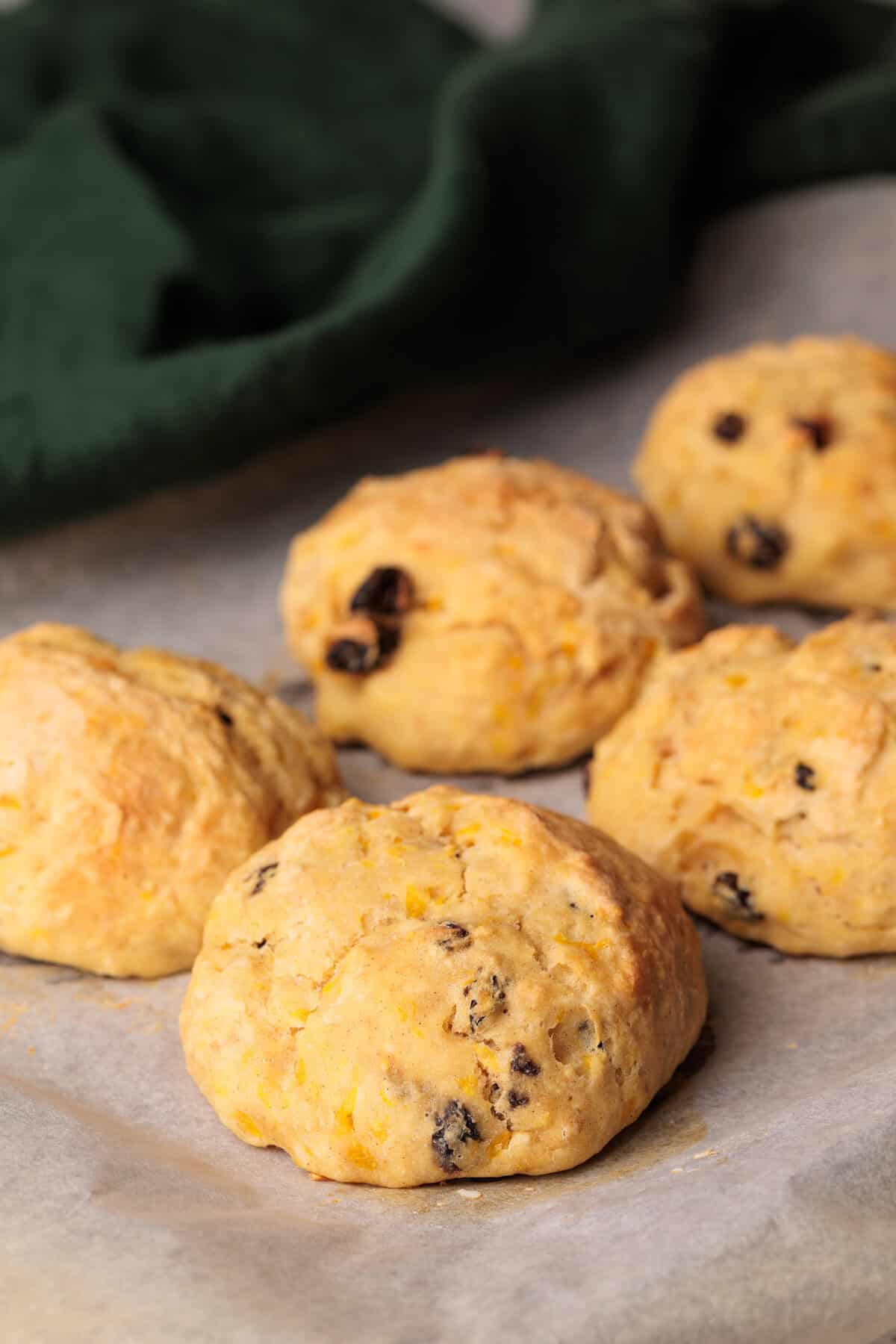 Spiced Fruit Bread Rolls on parchment paper.